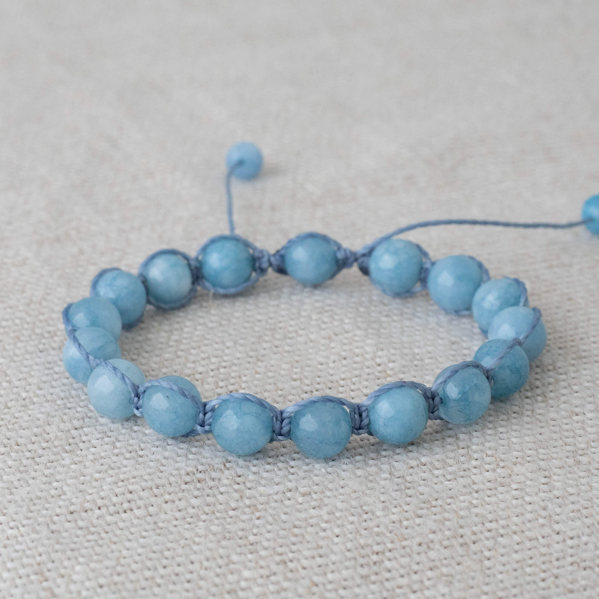 Blue macrame bracelet made with Aquamarine beads combined with light blue waxed polyester thread. Bracelet is adjustable with a sliding knot