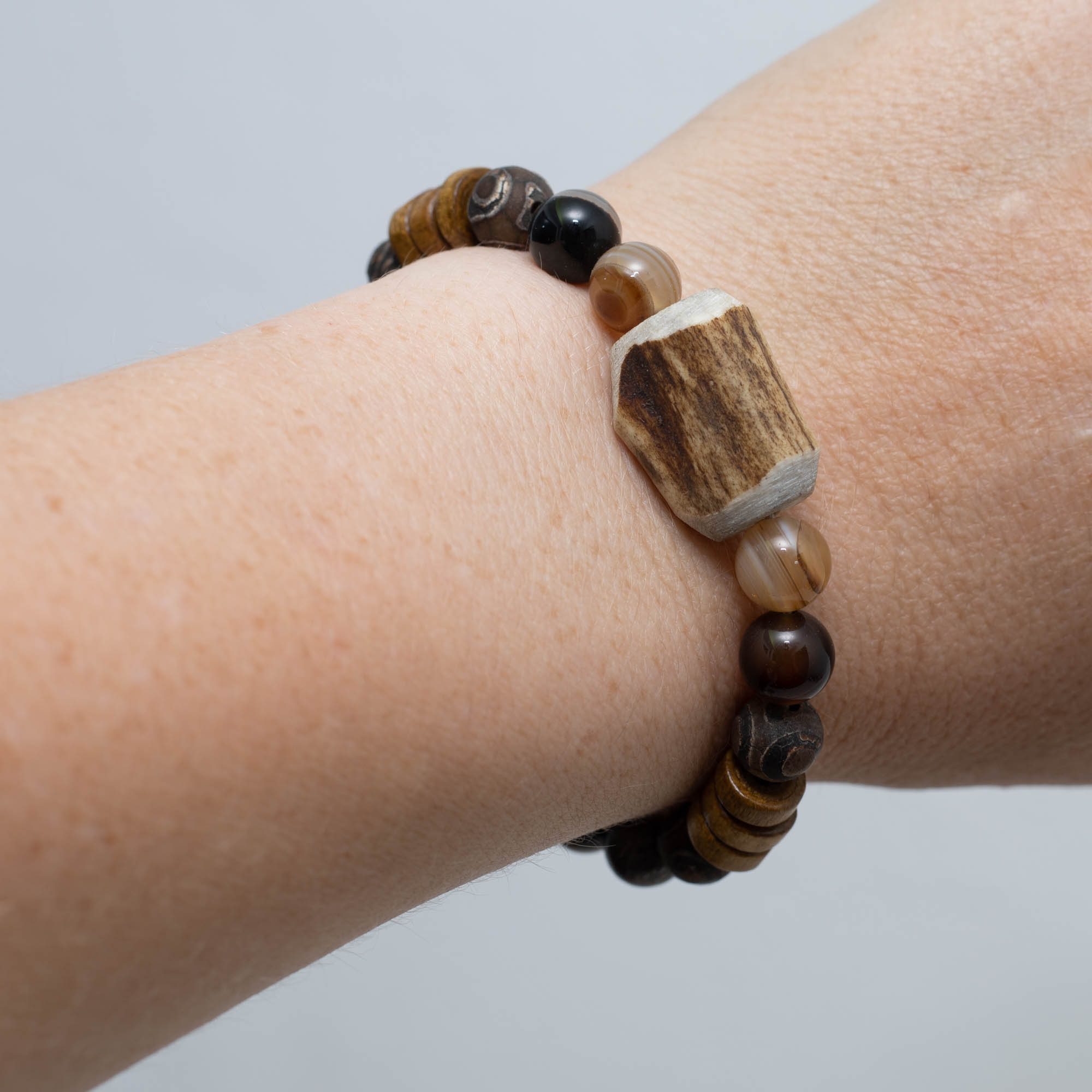 Armband aus Hirschgeweih, Lavastein, tibetischem Dzi-Achat, Bronzit, braunem Achat und Holzperlen vereint natürliche Materialien mit modernem Stil