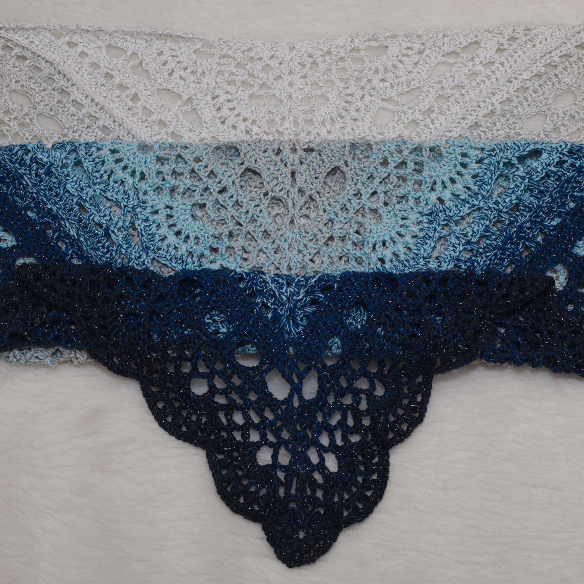 Handgefertigtes Dreieckshäkel-Tuch aus Ombre-Garn von Grau zu Mitternachtsblau mit funkelnden Silberfäden – elegant, vielseitig und perfekt für den Alltag.