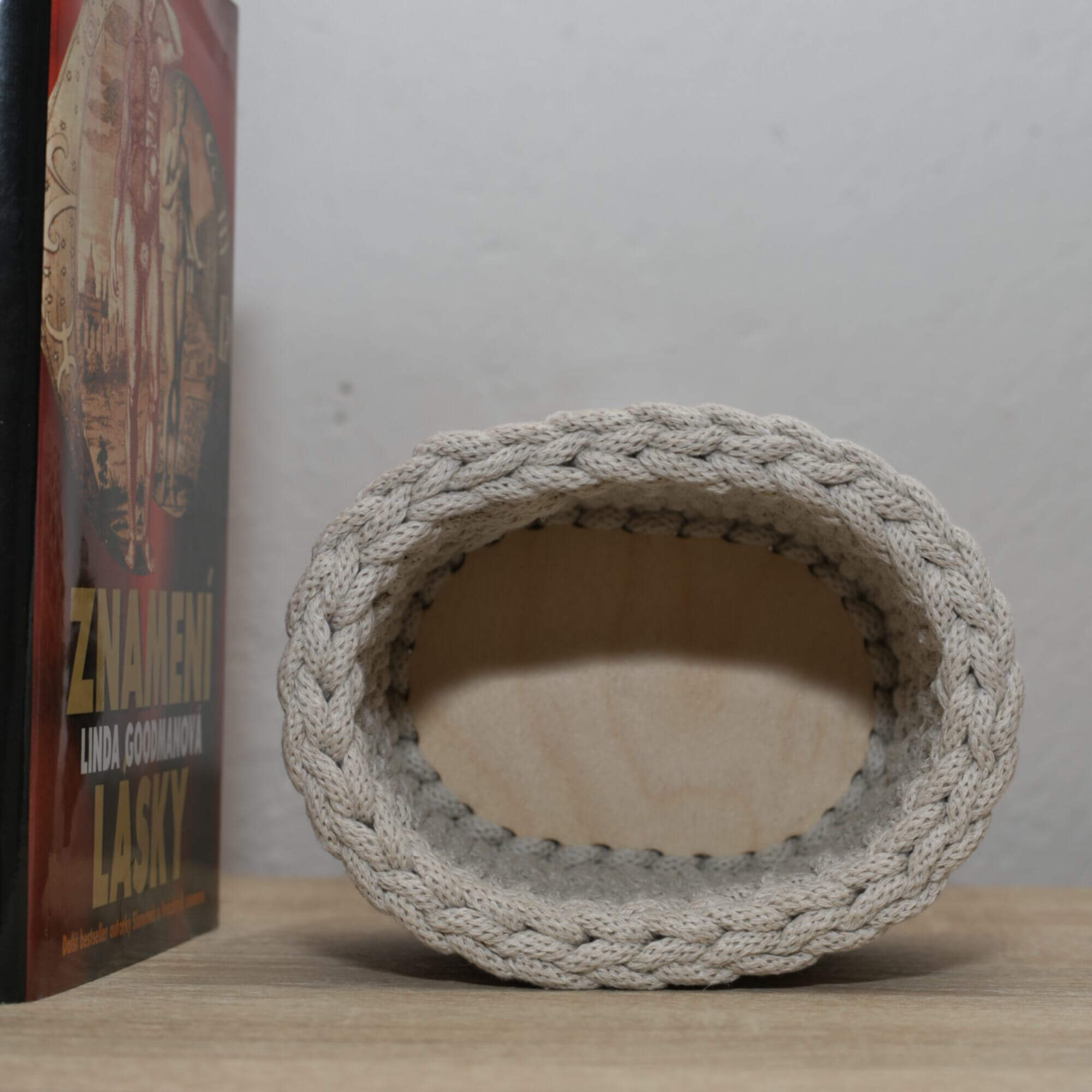 Small beige oval shaped crochet basket made of recycled cotton cord.