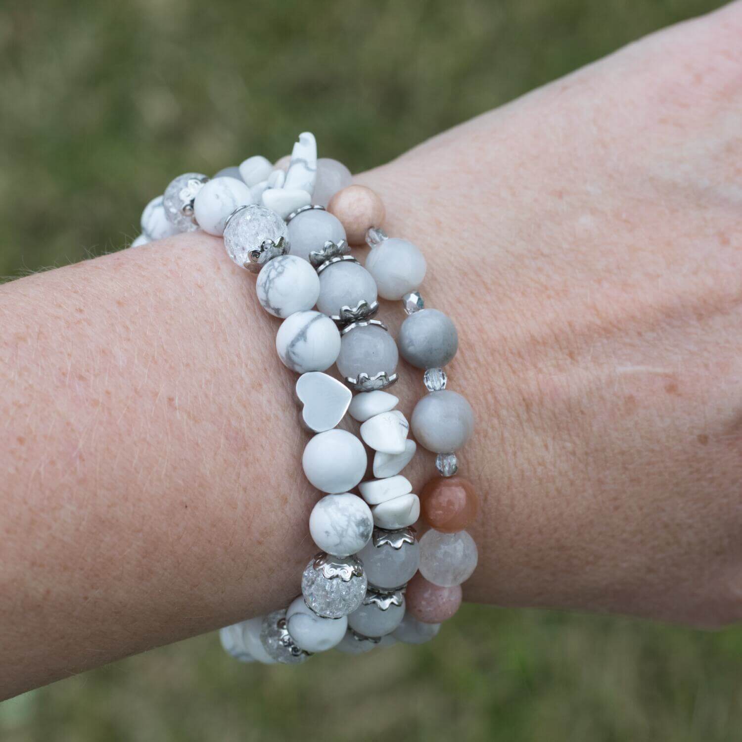 Elegant white bracelet for women. It features beautiful Howlite and Crystal Quartz beads, complemented by stainless steel accents and a heart-shaped bead.