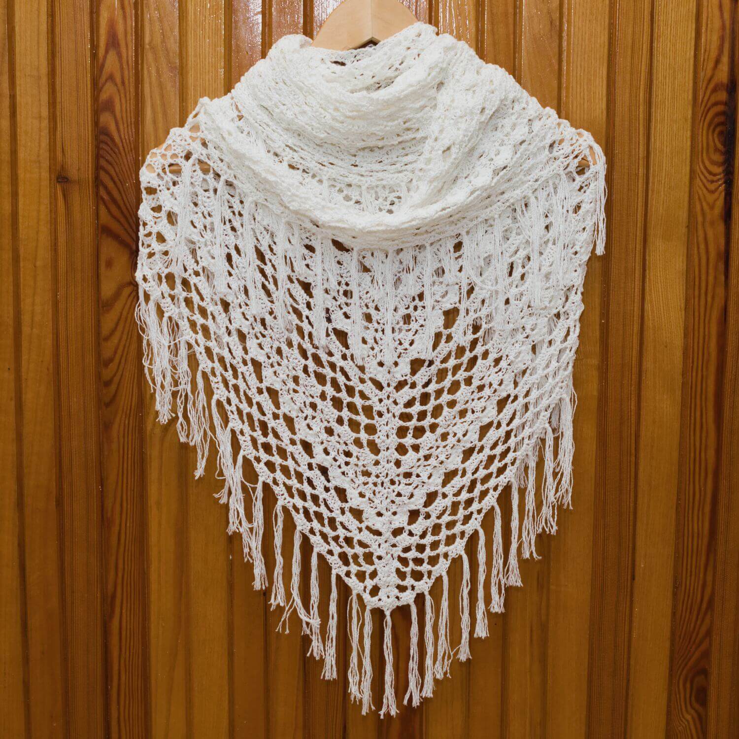 White triangular crochet shawl for women.