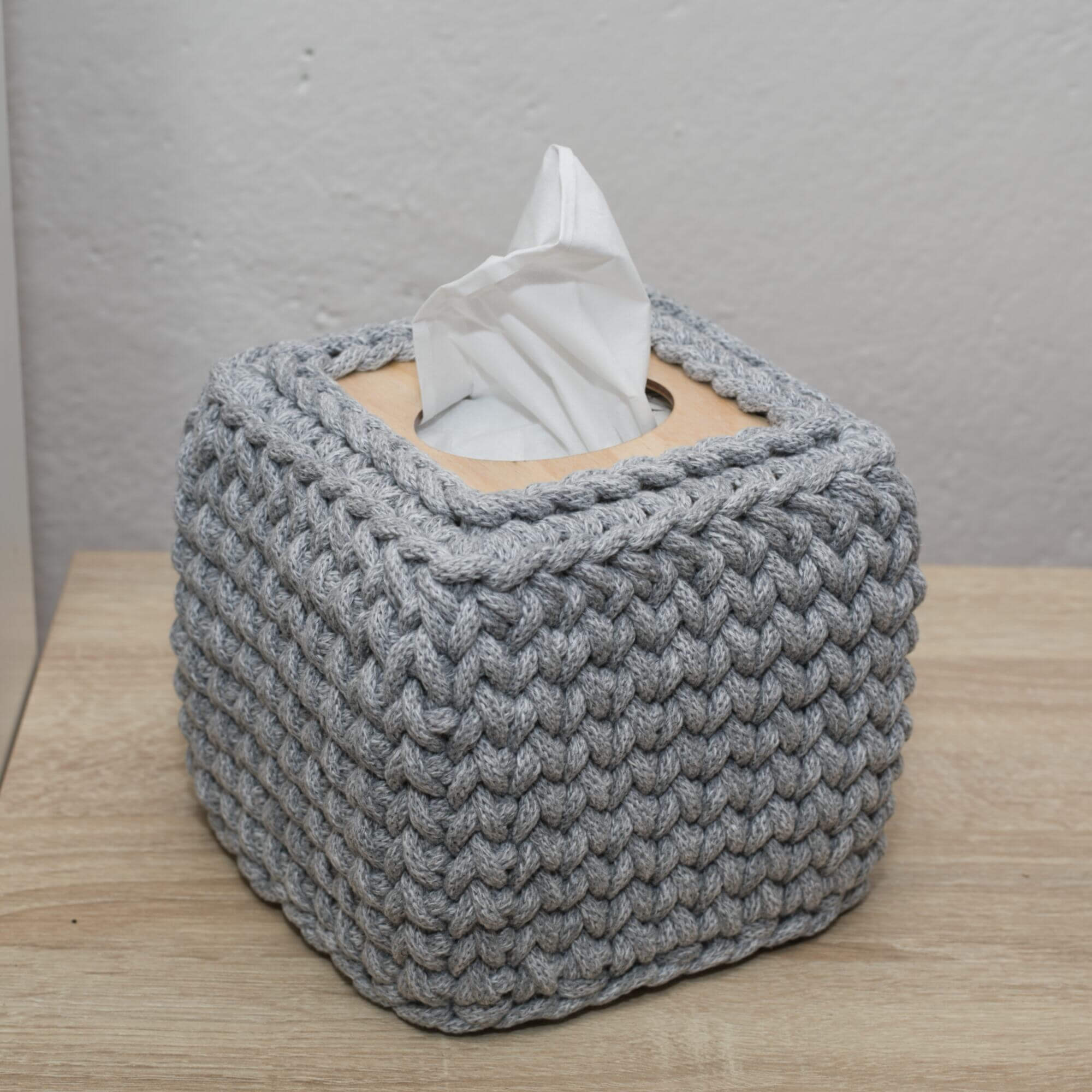 Sturdy grey crocheted square tissue box cover made of chunky recycled cotton cord and lacquered beech plywood.